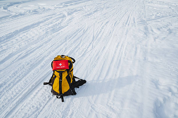 istock A yellow and black backpack is sitting in the snow 2211395526
