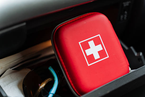 istock A bright red first aid kit featuring a prominent large white cross is securely positioned in a car, highlighting its crucial role in effectively handling medical emergencies when they arise 2211395551
