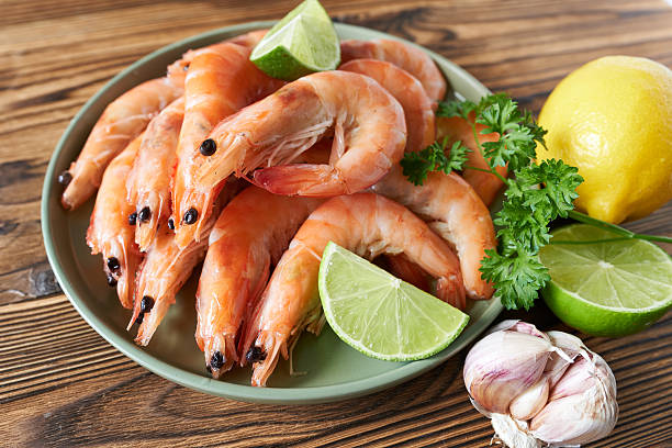 istock Shrimps with lime and parsley on plate, closeup 2211396873