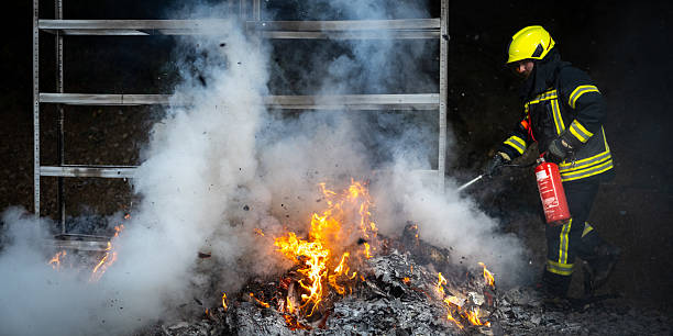 istock Fireman Extinguishing Flames with Fire Extinguisher 2211397349