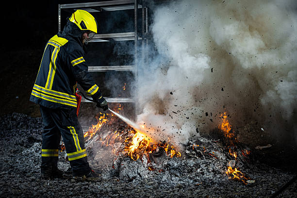 istock Firefighter extinguishing fire with extinguisher 2211397913