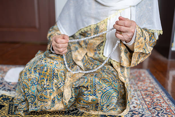 Senior Muslim Woman Praying At Home