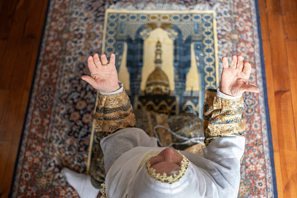 Senior Muslim Woman Praying At Home