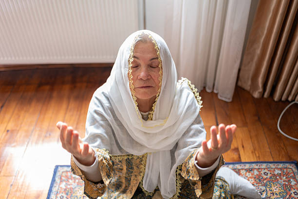 Women with a headscarf worships at a church.