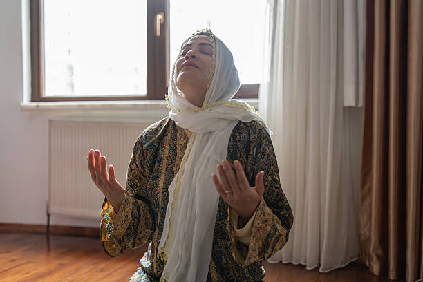 Young caucasian woman sits on a bench in the church and prays