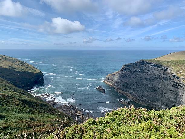 istock Tall grass covered cliffs rolling down to cove in England 2211402326