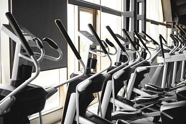 istock Elliptical cross trainer machines in a row in a modern gym 2211402930