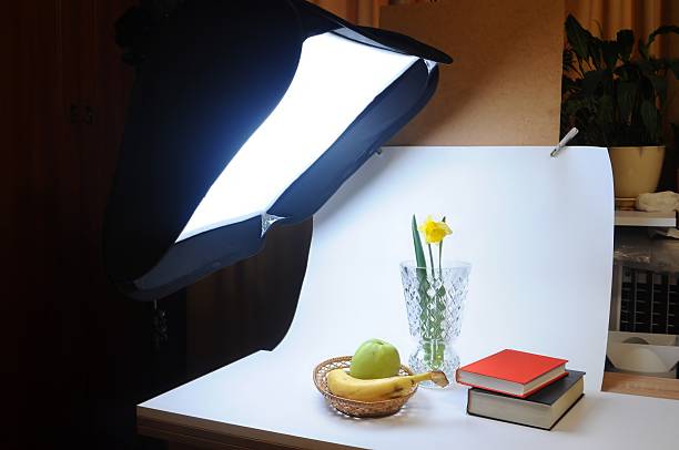 istock A beautiful still life composition showcases a daffodil, fruits, and books under studio lighting. 2211403267