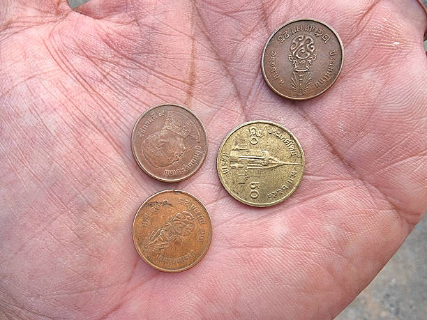 istock Thai Baht Coins Including 50 Satang and 25 Satang on a Palm 2211403547