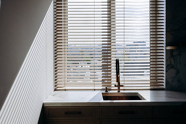 istock This is a kitchen featuring a sink along with a window that has blinds 2211406747