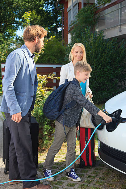 istock Family Charging Electric Car Before a Trip 2211406777