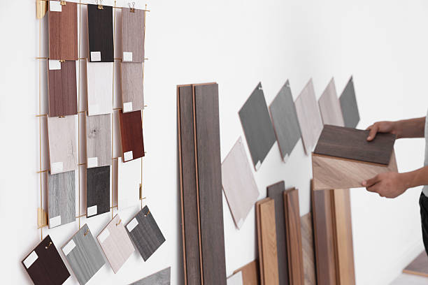 istock Man with different samples of wooden flooring indoors, closeup 2211408369
