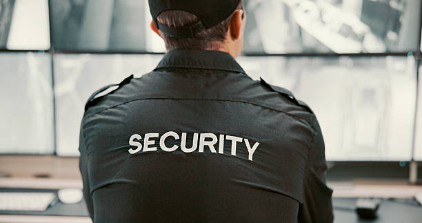 istock Camera, security and back of person on computer screen for surveillance, inspection and monitoring. Observation, footage and guard on monitor for protection, patrol or building safety in control room 2211409072