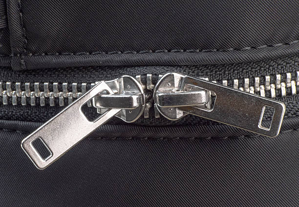 istock Close-up view of a zipper on a black fabric material 2211409270