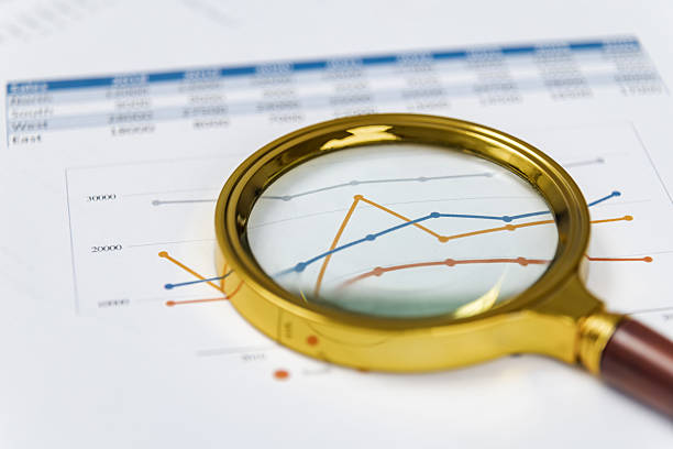 istock Analyzing financial data trends with magnifying glass for better insights and understanding 2211409535