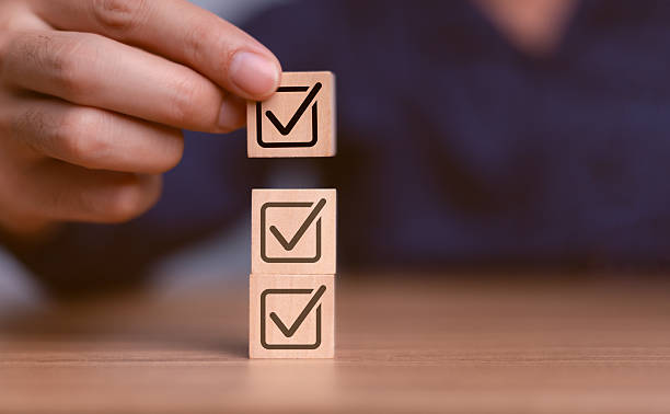 istock Checklist concept, business person checklist tick answer sign in checkbox, validation online questionnaire quality control document, man use pen to tick correct sign mark in checkbox form. 2211410404