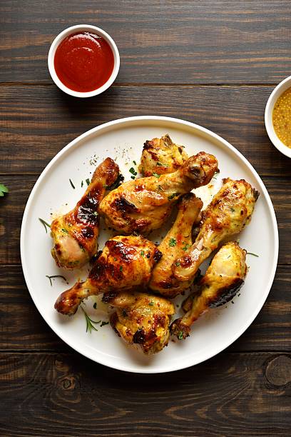 istock Bbq roasted chicken drumsticks served with sauce 2211410831