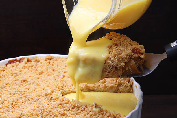 istock Apple Crumble pouring with Custard Cream 2211410990