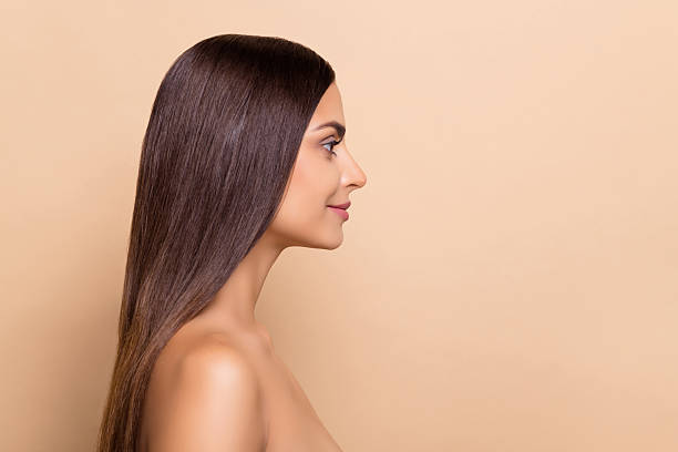 istock Profile side view portrait of attractive brown-haired girl copy blank space ad solution isolated over beige pastel color background 2211411333