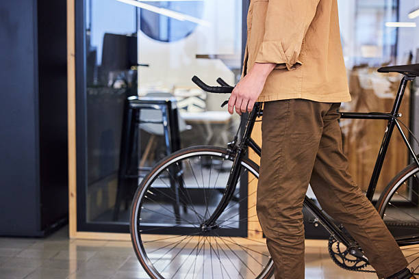 istock An unrecognizable person is walking with a bicycle in the office. 2211412419