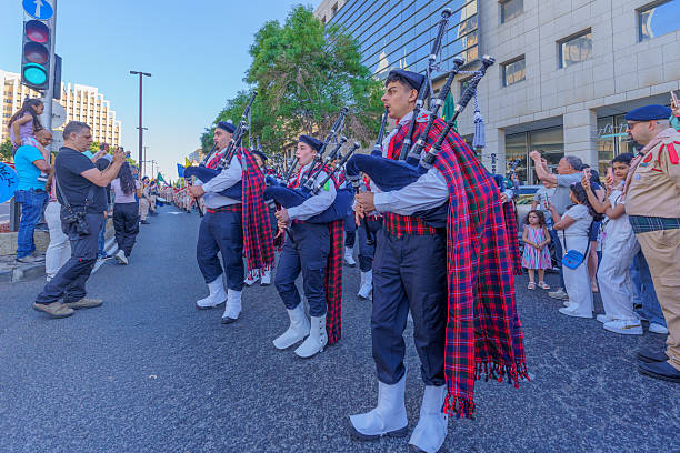 Calgary, Alberta, Canada. Nov 11, 2025. Pipe and drum band in traditional Scottish military dress marching in formation at Remembrance Day parade in Calgary Memorial Park.