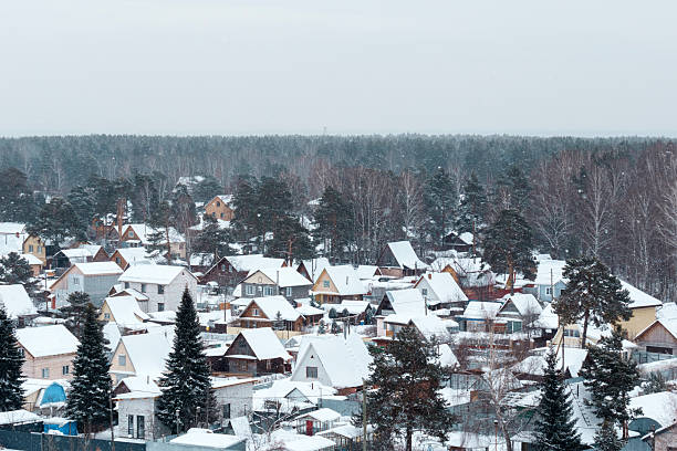 istock Winter envelops a tranquil village with snow-covered rooftops and quiet streets amidst a frosty landscape 2211412914