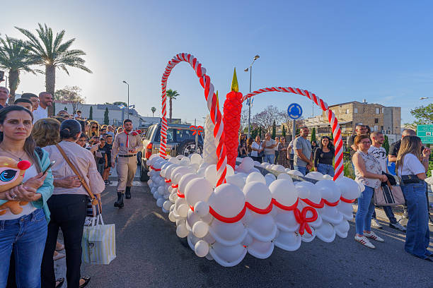 Haifa, Israel - April 19, 2025: Local Arab Orthodox Christians scouts celebrate Easter Holy Saturday by a parade with holy fire candles. Downtown Haifa, Israel