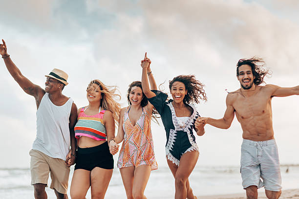 istock happiness friends running together at the beach 2211416514