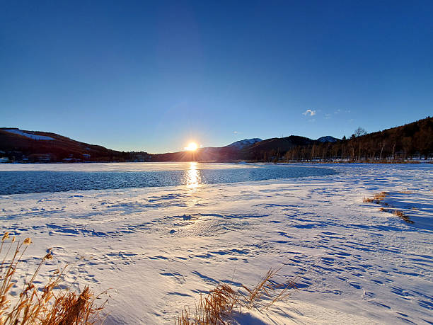 The sun shining on the frozen lake (Lake Shirakaba, Nagano Prefecture)