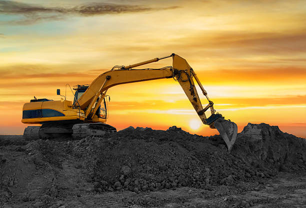 istock Excavator working at construction site. Backhoe during earthworks. Digging ground for the foundation and for laying sewer pipes district heating. Earth-moving heavy equipment 2211418980