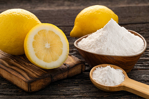 istock Bowl and spoon with baking soda and sliced lemons - Citrus Limon 2211419949