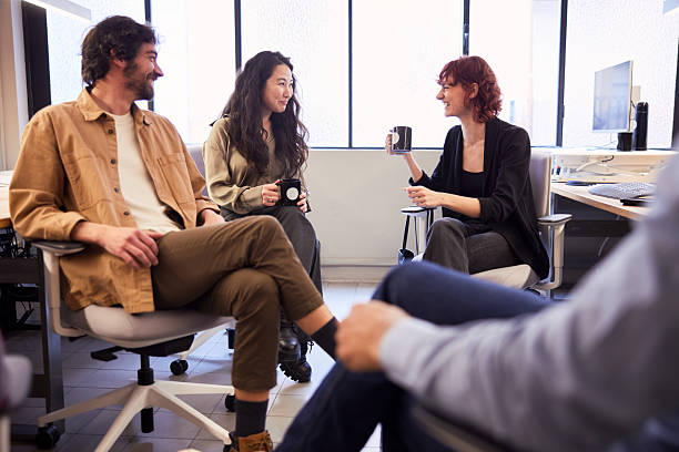 istock Colleagues step away from their computers to converse with one another. 2211420038