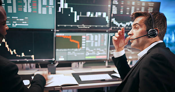 istock Men, headset and graphs for stock market, talking or computer screen for consulting at investment agency. Business people, partner and discussion with charts for profit, revenue or trading by monitor 2211420409