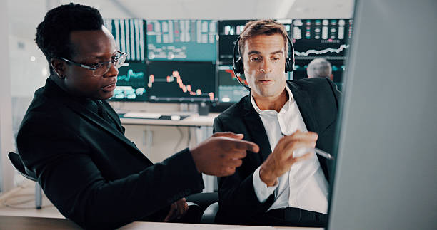 istock Men, headset and talk with computer for trading plan, stock market increase and review financial growth. People, trader and pointing for problem solving advice, value update and monitor investment 2211420551