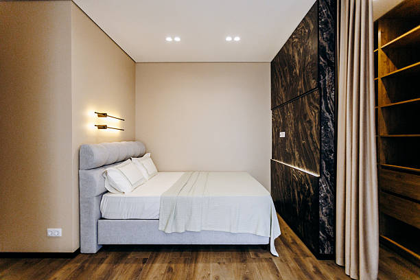 istock A cozy and inviting bedroom featuring a large bed and an expansive window 2211421117