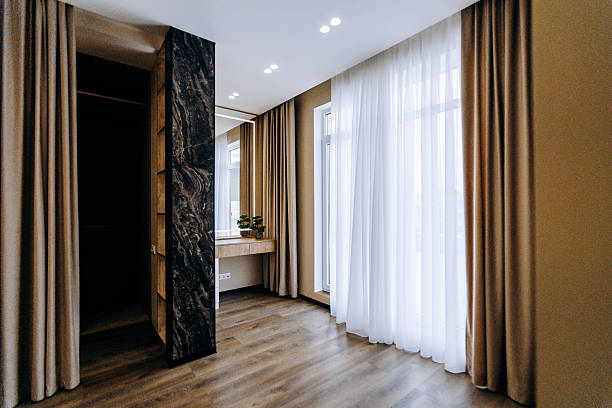 istock A spacious room featuring a large window adorned with elegant curtains 2211421254
