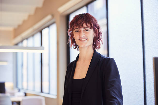 istock A young office worker in a suit poses for the camera. 2211421272