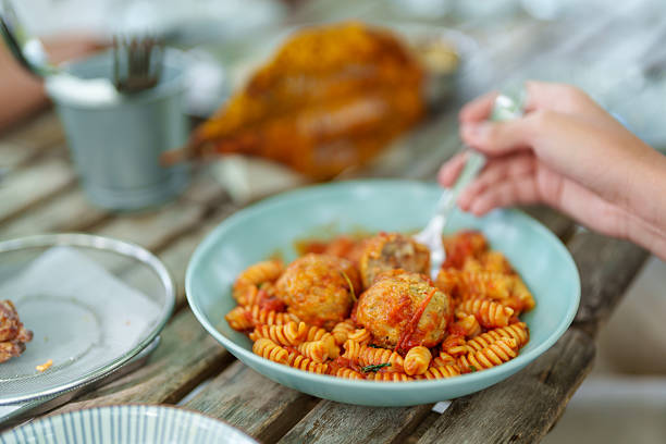 Spiral Pasta with Meatballs in Tomato Sauce on Rustic Table