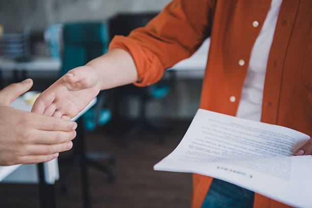 istock Casual business exchange as two people engage in a professional handshake inside a modern workspace during a collaborative meeting. 2211424188