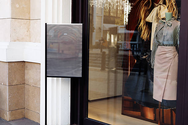 istock Storefront featuring a window display with mannequins and clothing in an urban setting 2211426530