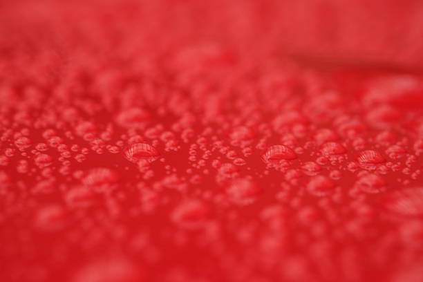 water droplets on the surface of a red shiny background