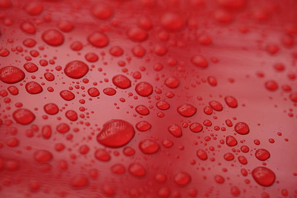 istock water droplets on the surface of a red shiny background 2211428652