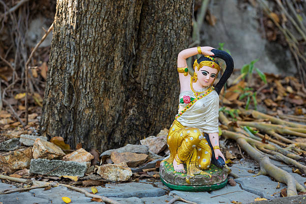 Colorful Phra Mae Thorani statue under tree on Big Buddha Temple area in Pattaya, Thailand. Vasundhara or Dharani is a chthonic goddess from Buddhist mythology of Theravada in Southeast Asia.