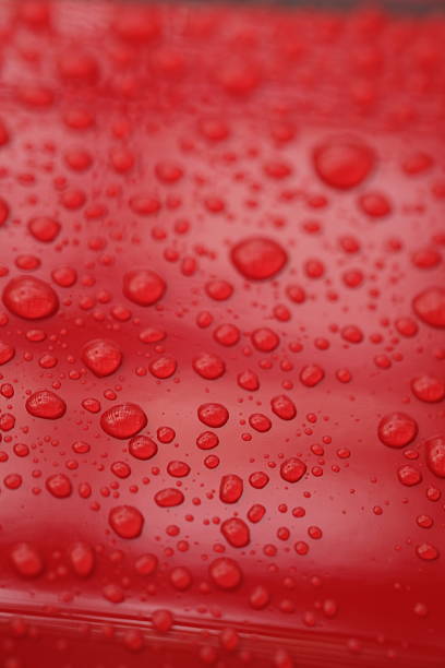 istock water droplets on the surface of a red shiny background 2211429384