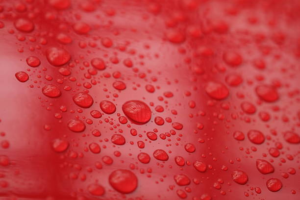 istock water droplets on the surface of a red shiny background 2211429434