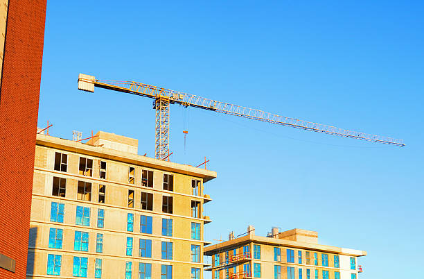 istock Construction cranes on on blue sky background. Tower Crane on building construction. 2211431113