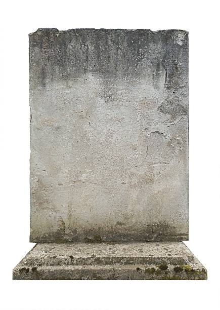 istock Simple stone wall with base, natural wear and tear patterns, empty gravestone 2211432925