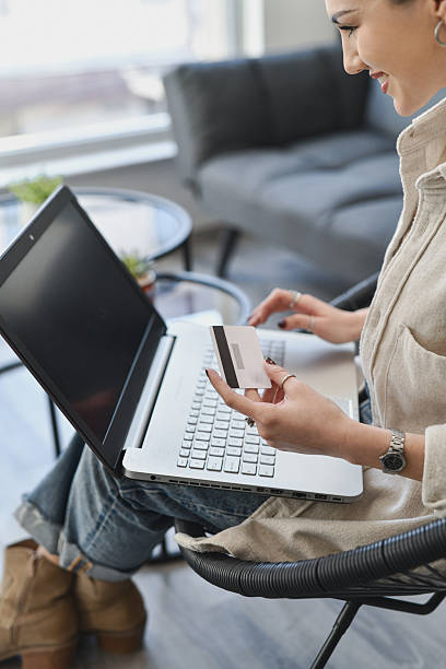 istock Smiling Woman Settling Online Subscription Fee Using Card and Laptop 2211433467