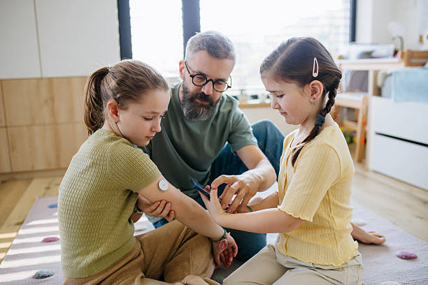 istock Diabetic girl with a CGM sensor on her arm. 2211436375