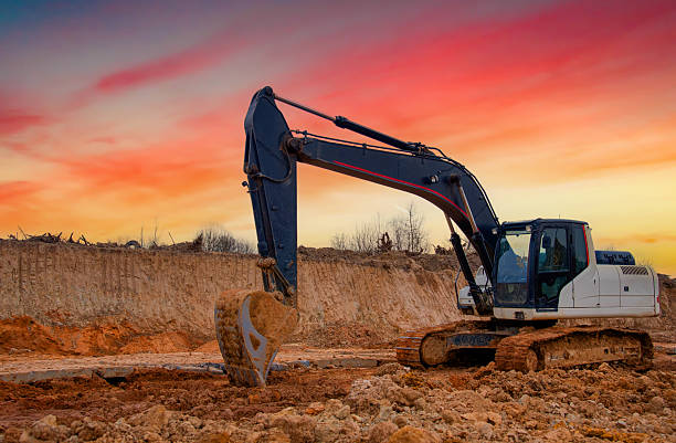 istock Excavator on sunset. Open-pit mining. Backhoe dig ground in quarry. 2211436758